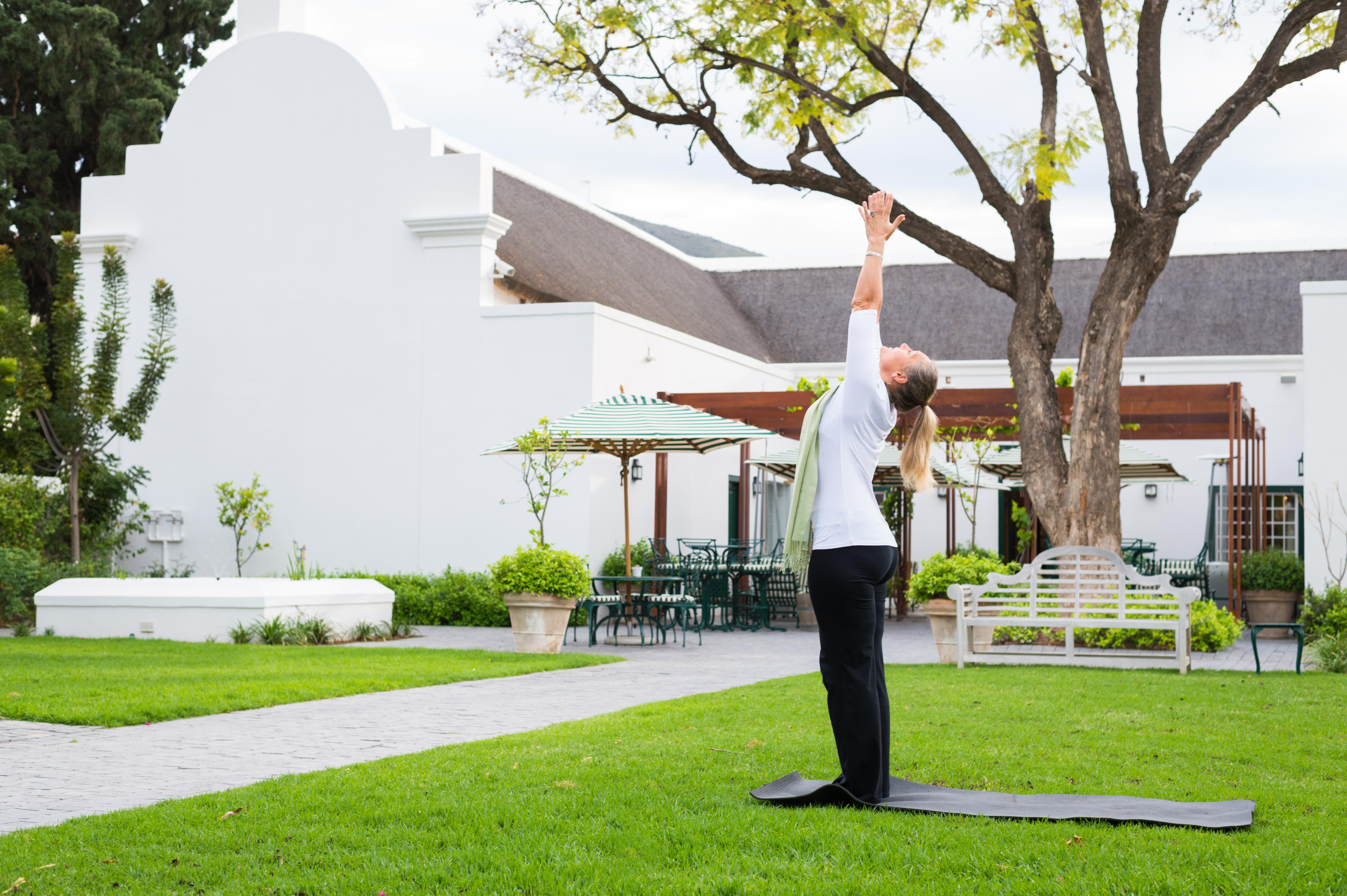 Drostdy Hotel Graaff-Reinet Exterior foto A woman practicing yoga at the Cape of Good Hope
